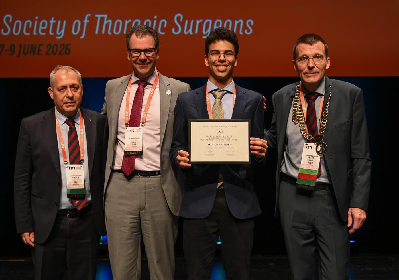 Mathias Ribeiro receiving the SBCT annual meeting travel grant on stage at ESTS 2026